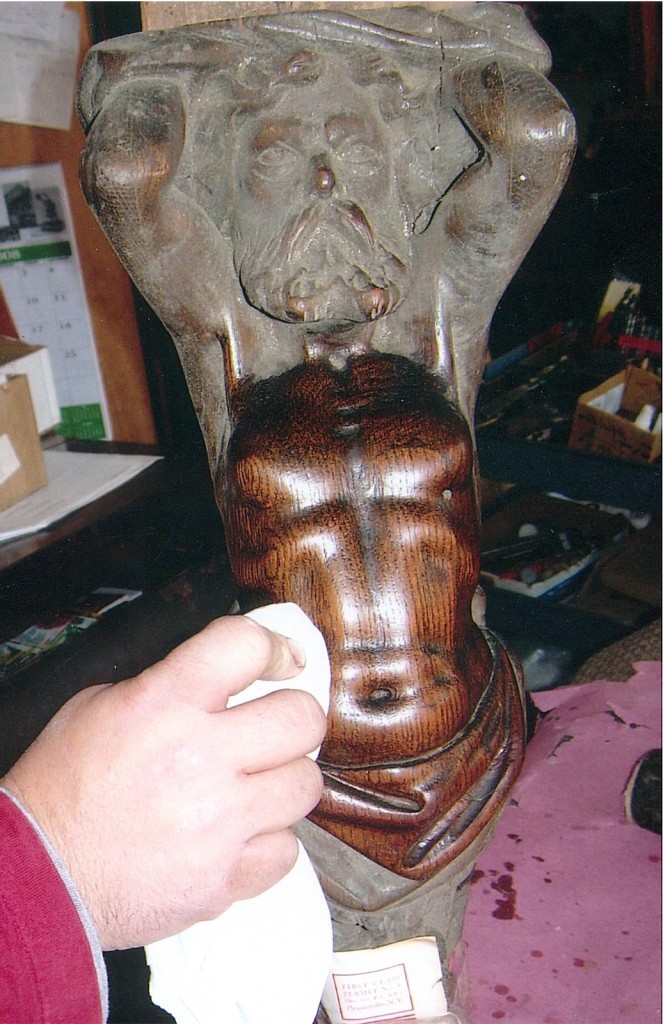 careful finish restoration of 19th Century gargoyle.