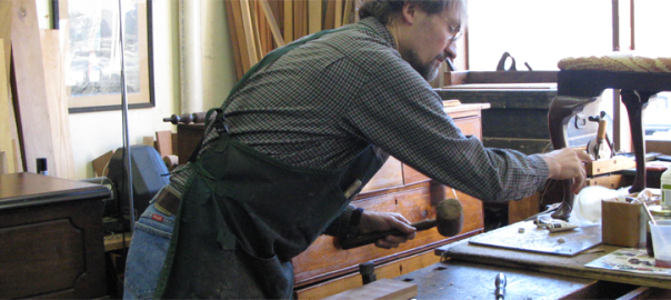 Erick Clingen restoring an antique chair in his Westchester County workshop