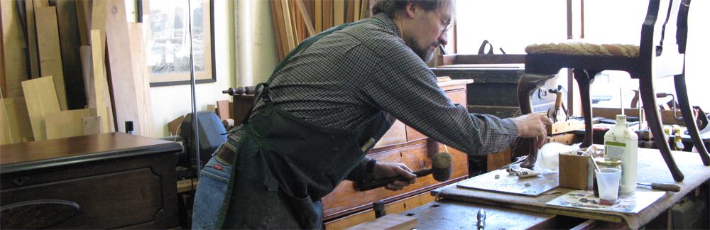 Erick Clingen restoring an antique chair in his Westchester County workshop